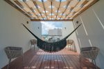 The IT Residences rooftop area with patio area and hammock